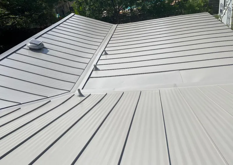 Solar attic fan installed on a metal roof for Roof Ventilation in Seabrook
